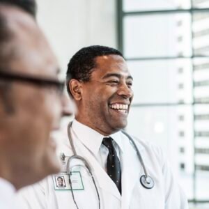 Black man doctor in lab coat with a stethescope.